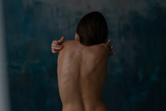 Back view of woman embracing back by hands at blu deep studio