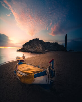 Sunrise in the beach with boats