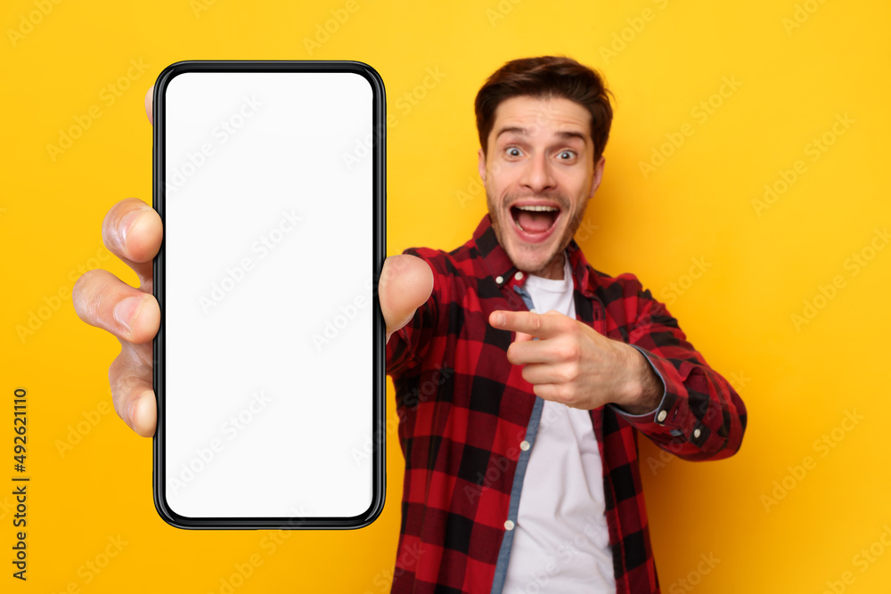 Aufkleber shocked guy pointing at white empty smartphone screen