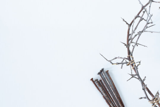 Thorn crown with rusty nails isolated on white background with copy space. Top view. The biblical concept of God Jesus Christ love, suffering, the forgiveness of sins, and salvation for eternal life.