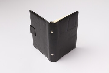 open black leather diary from the back on a white background