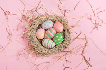 nest with Easter eggs on a pink background. High quality photo