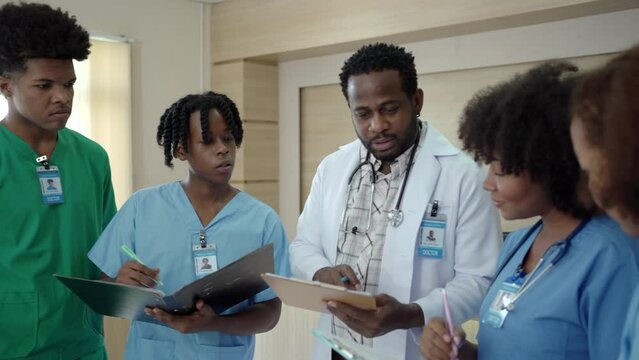 Group of American - African ethnicity medical student or intern doctor in general hospital making a discussion.