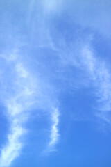Beautiful white feathery clouds spreading on vibrant blue sky