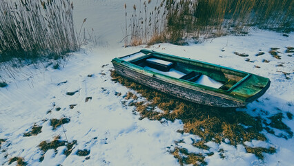 Old abandoned boat sitting under a dusk sky