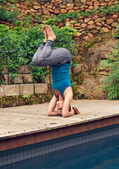 Keeping her mind and body strong. Full length shot of a young woman practicing yoga.