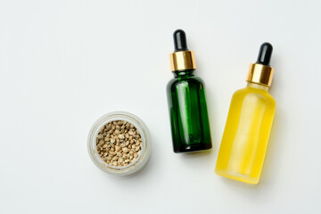 Marijuana cosmetic products, CBD oil. Medicinal hemp extract in cosmetic bottles on white background. Natural herbal care, medical usage, cannabis therapy.