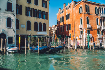 Fototapeta na wymiar Venice Italy - view on Grand Canal with famous gondola taxi station and old houses along embankment, ancient architecture buildings for exploring during water sightseeing on travel vacations