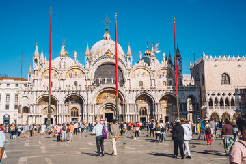 Fototapeta na wymiar Ancient Basilica San Marco on famous piazza square located in romantic Italian city - Venice - perfect place for summer vacations, beautiful architecture building discovering during touristic journey