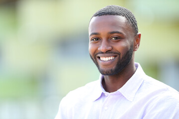 Handsome happy man with black skin looks at you