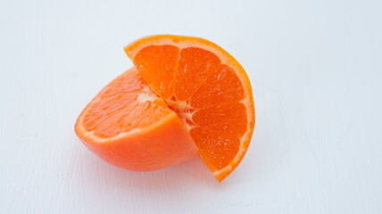Close up of ripe orang mandarin, clementine cut with half slice isolated on white background, cross section organic tangerine two piece. tangerines lay across, tropical fruit with c vitamin