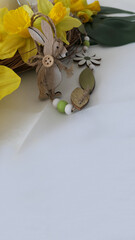 easter greeting card with happy rabbit decoration and daffodils copyspace