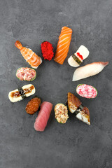Sushi set from different rolls. Photo of food on a dark background