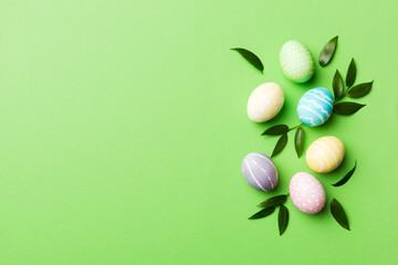 Colorful Easter eggs with spring flower leaf isolated over white background. Colored Egg Holiday border