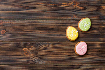 holiday preparation Multi colors Easter eggs with cookies on colored background . Pastel color Easter eggs. holiday concept with copy space