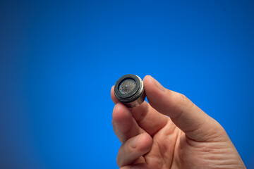Old dirty limescale covered clogged up tap water faucet strainer or aerator held in hand by...