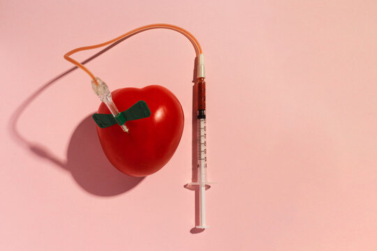 Conceptual image that represents blood donation represented by a tamonate and a needle with a wing nut for drawing blood. world blood donor day. Copy space