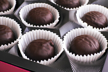 Closeup of box full of chocolate candies.