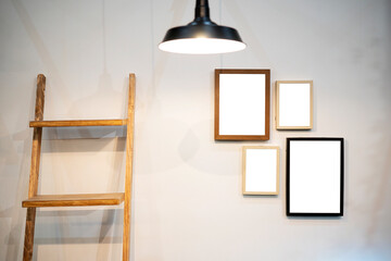 Cropped shot of stylish workspace with mock up frame, stationery in living room.