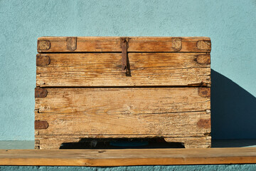 Old wooden chest near the wall sunlight