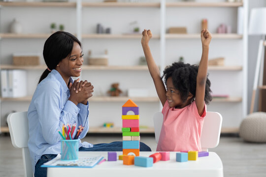 Smart little black girl having session with child development specialist