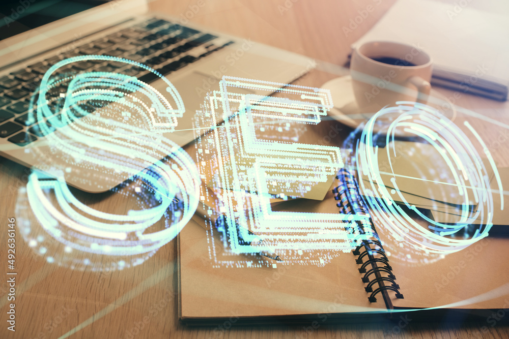 Poster Double exposure of SEO writing and desktop with coffee and items on table background. Concept of search optimization.