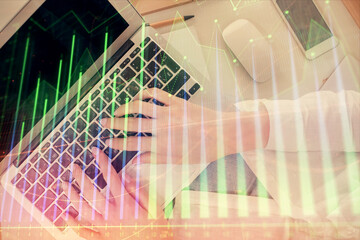 Double exposure of woman hands working on computer and forex chart hologram drawing. Top View. Financial analysis concept.