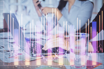 Multi exposure of woman hands typing on computer and forex chart hologram drawing. Stock market analysis concept.