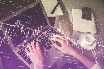 Double exposure of woman hands typing on computer and forex chart hologram drawing. Stock market invest concept.