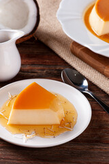 Delicious condensed milk and coconut pudding on a white plate.