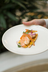 Sea food toast with shrimps hand holding plate of food