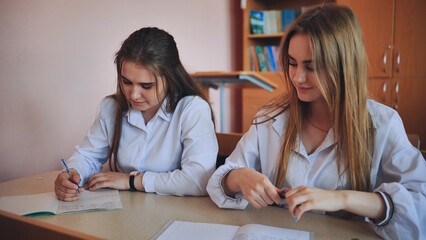 Fototapeta premium Pupils of the 11th grade in the class at the desks during the lesson. Russian school.