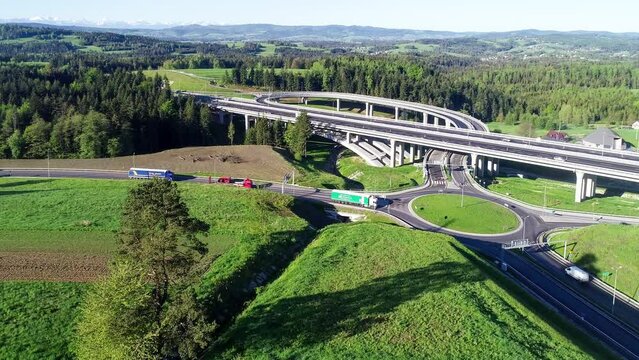 New highway in Poland on national road no 7, E77, called Zakopianka.  Overpass crossroad with a traffic circle, slip roads and viaducts near Skomielna Biala. Aerial video. Far view of Tatra Mountains