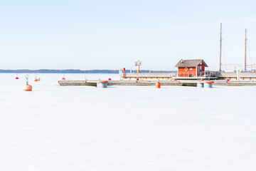 Early spring ice remains and the boat slips are embpty  in early March at the harbour in Orjaku.