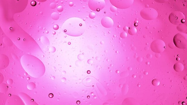 Super Slow Motion Shot of Oil Bubbles on Light Pink Background at 1000fps. Shoot on high speed cinema camera.