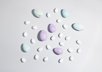 Happy Easter concept. Easter eggs isolated on a modern pastel blue background. A simple minimalist view of the flat lying top view