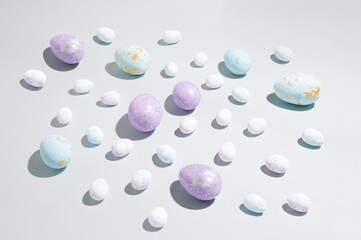 Happy Easter concept. Easter eggs isolated on a modern pastel blue background. A simple minimalist view of the flat lying top view from the side