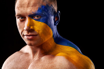 Flag of Ukraine painted on a face of soldier. War between Ukraine and Russia
