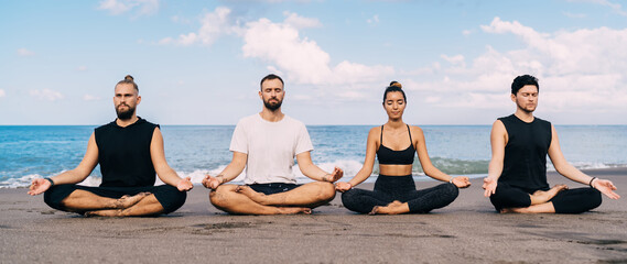 Men and woman with closed eyes sitting in lotus pose meditating feeling mindfulness and...