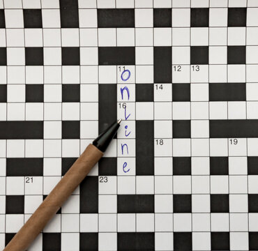 Crossword Puzzle With Pen The Word Online Ruchla From Recycled Material Is Written Next To Top View Of The Free Space