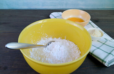 Bowl of Mixture with some Ingredients for baking Brazilian cheese bread or Pao de Queijo