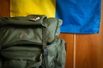 Military backpack. flag of ukraine on the background. close-up.