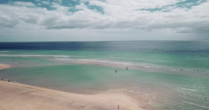 Amazing tropical beach anc blue transparent sea ocean water. Aerial view of coastline and amazing seascape landscape with horizon and sky and mountains in background. Summer travel