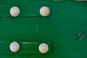 green background, four white buttons, green wooden board, painted green