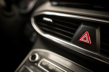 Triangle button on black car dashboard