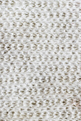 Texture of natural warm knitted fabric pattern white color.