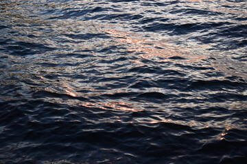 Waves on water. Water surface texture. Water ripples
