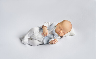 newborn baby boy in a suit sleeping on a  white background. Happy pregnancy and childbirth. Health concept. 