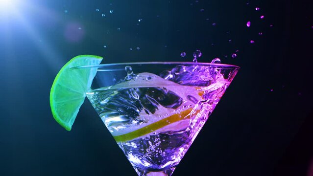 Super Slow motion shot of lime splashing into Dry Martini Drink. Filmed on high speed cinematic camera at 1000 fps.