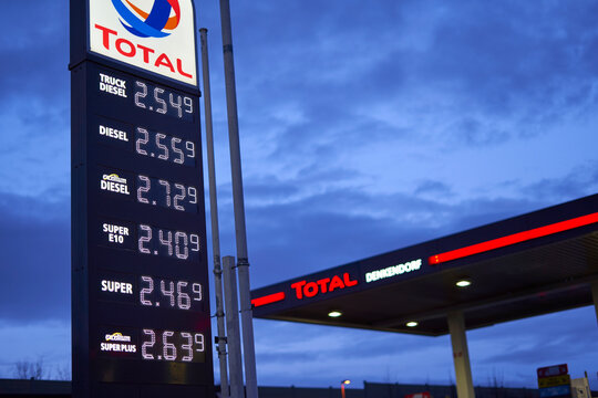 Price board with high gasoline, diesel and fuel prices. Most expensive gas and oil prices at German Total filling station (Tankstelle) in Europe. In the morning.